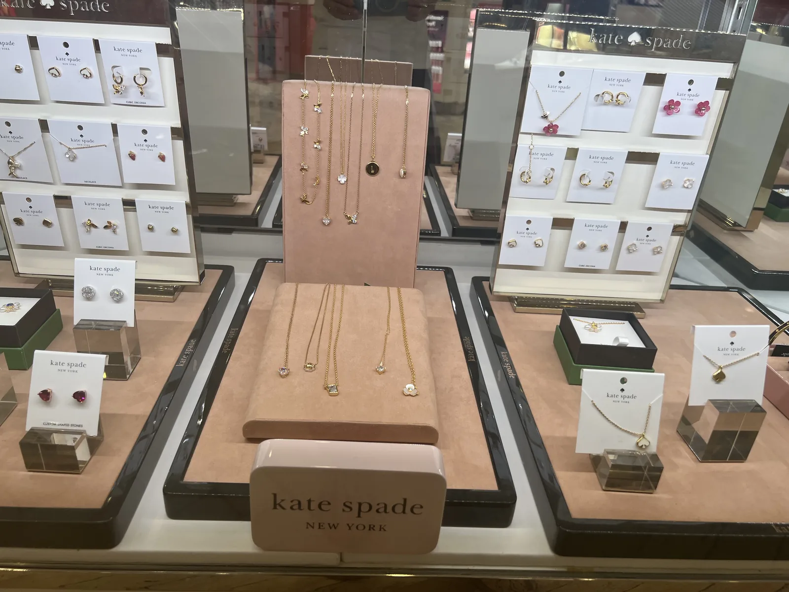 Macy's kate spade 柜台,锆石耳钉、项链在粉色绒托上陈列
